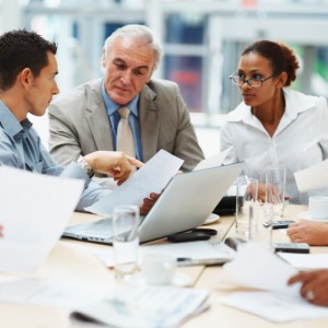 Multi ethnic business executives at a meeting discussing a work